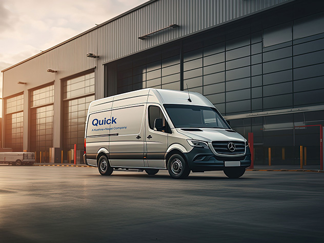 van with quick logo in front of a warehouse